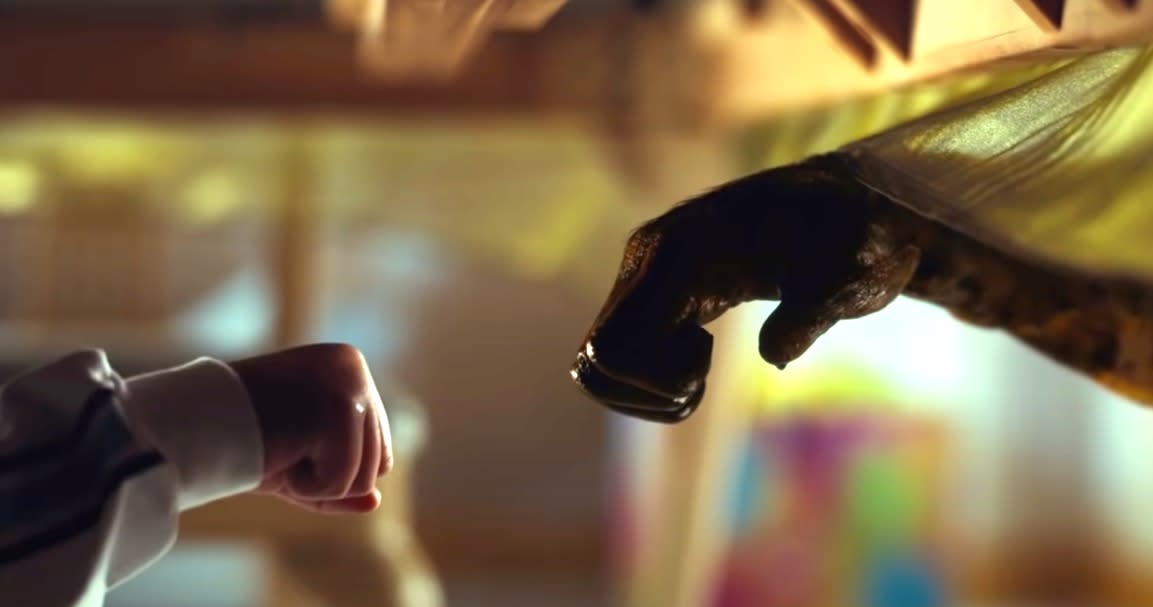 Scene from Jordan Peele's NOPE, as a kid and an alien fist-bump