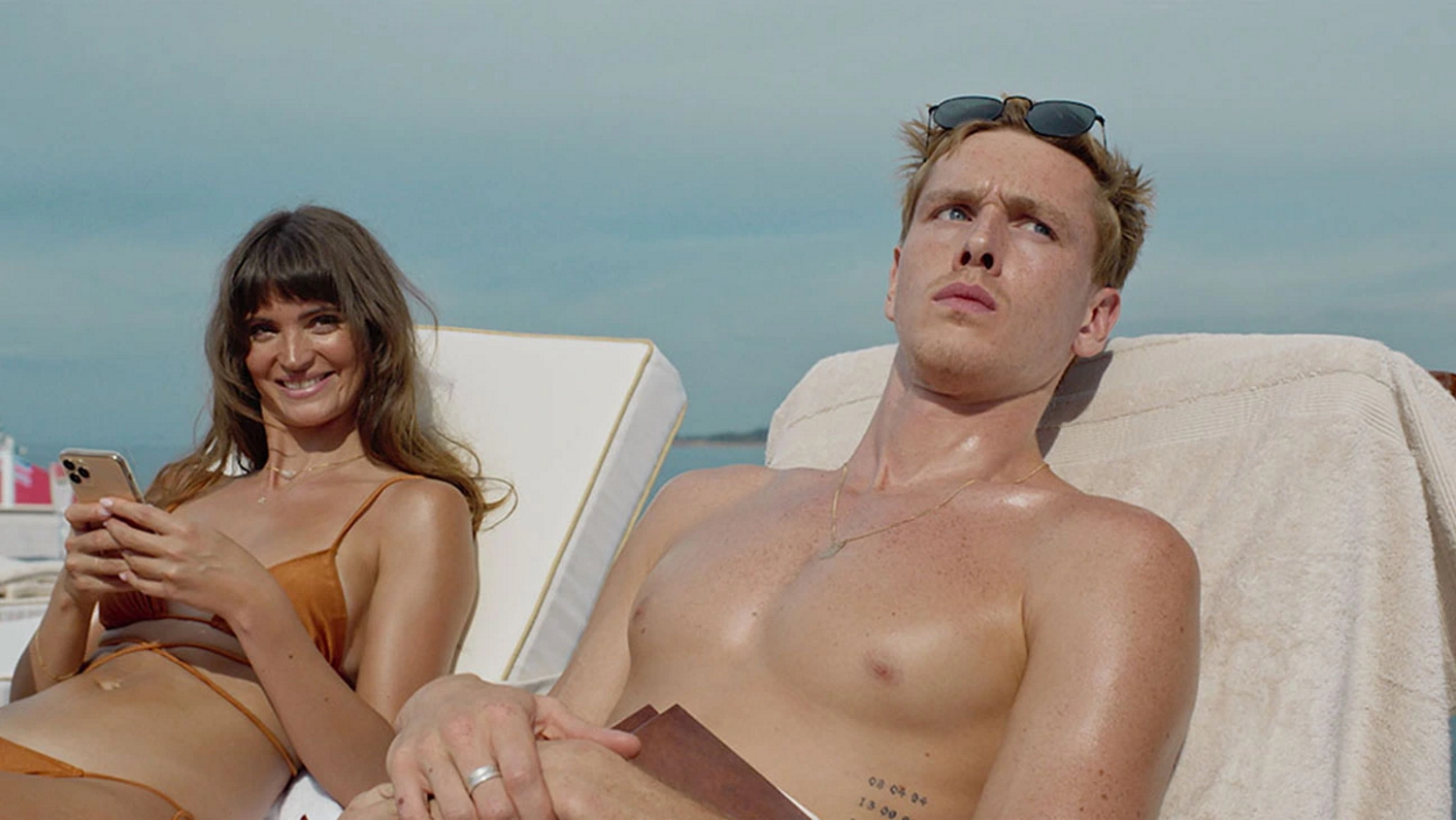 Charlbi Dean (left) and Harris Dickinson (right), co-starred in Ruben Ostlund's film, Triangle of Sadness alongside Woody Harrelson