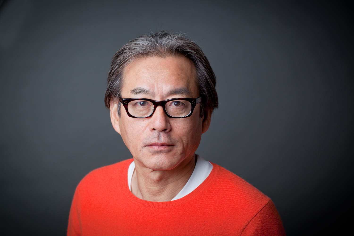 Japanese composer Shigeru Umebayashi posing for a photoshoot