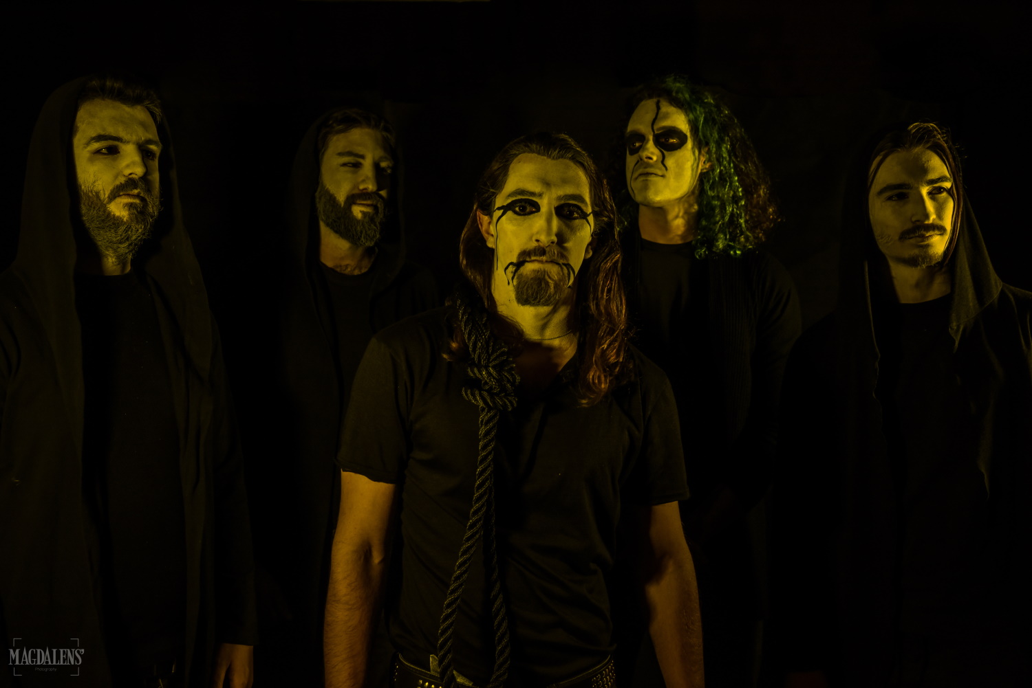 Greek black/death metal band Warhammer posing for a photoshoot in yellow light
